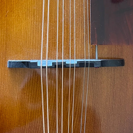 mandola strings with compensated downpressure